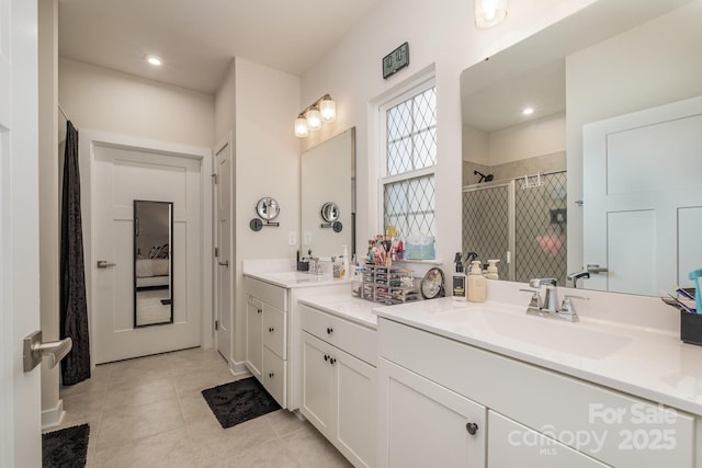 bathroom with vanity, tile patterned floors, and a shower with door