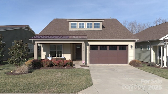 view of front of home featuring concrete driveway, metal roof, an attached garage, a standing seam roof, and covered porch