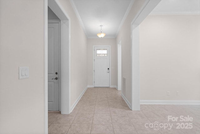 interior space with light tile patterned floors, ornamental molding, visible vents, and baseboards