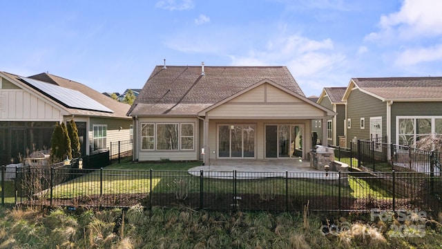 rear view of house featuring a fenced backyard, a patio, and a lawn