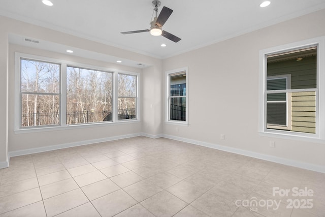 spare room with a ceiling fan, recessed lighting, crown molding, and baseboards