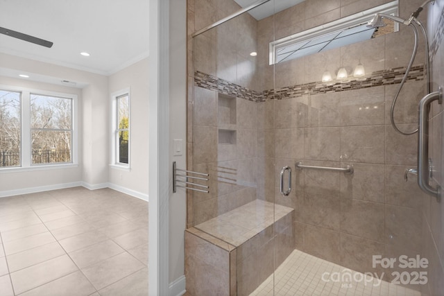 bathroom featuring tile patterned flooring, a shower stall, baseboards, and crown molding