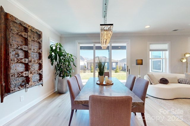 dining area featuring a wealth of natural light, light wood-type flooring, and ornamental molding