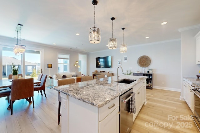 kitchen with white cabinets, sink, a kitchen island with sink, and stainless steel appliances