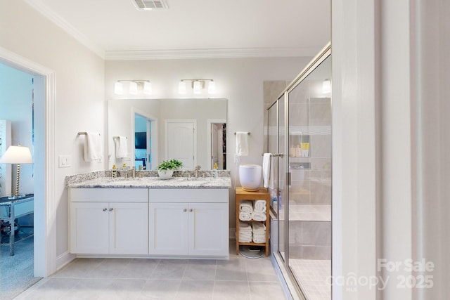 bathroom featuring vanity, an enclosed shower, and crown molding