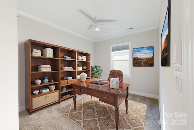 home office featuring ceiling fan, ornamental molding, and light carpet