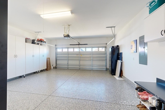 garage with electric panel and a garage door opener