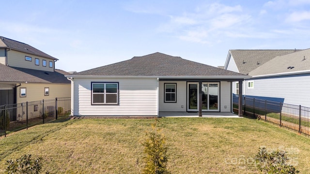 back of property with a lawn and a patio area