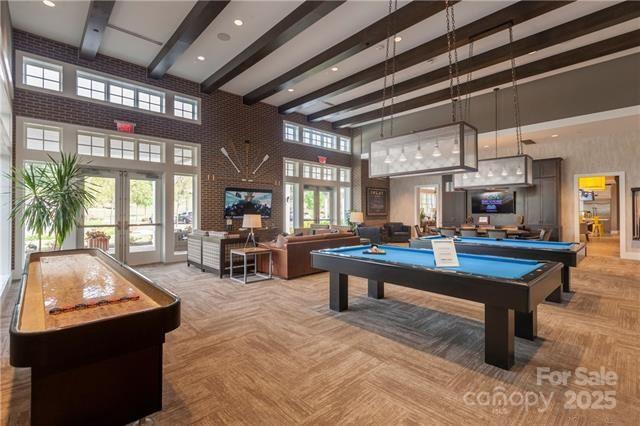 playroom with a high ceiling, french doors, billiards, parquet flooring, and beamed ceiling