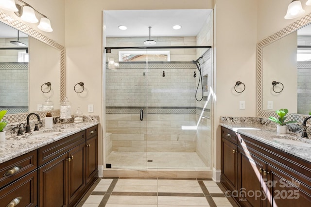 bathroom featuring tile patterned flooring, vanity, and a shower with shower door