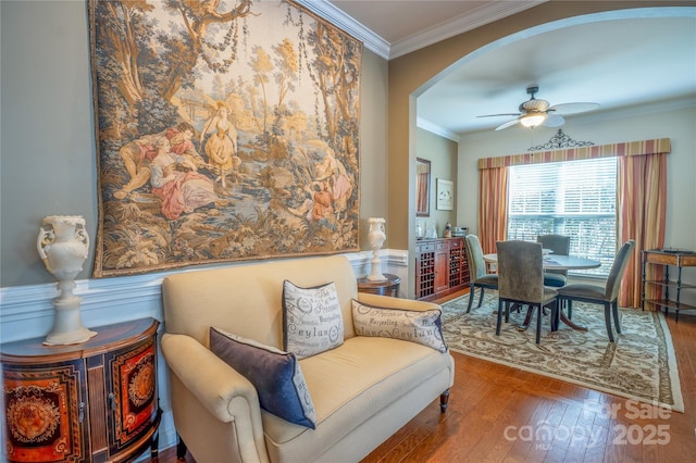 sitting room with ceiling fan, hardwood / wood-style flooring, and ornamental molding