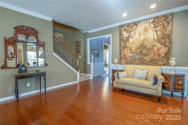 living area with crown molding and hardwood / wood-style floors