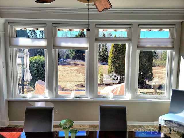 interior space with plenty of natural light and crown molding