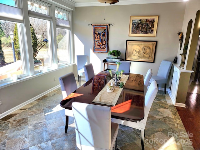 dining space with ornamental molding