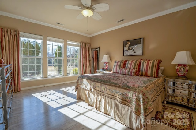 bedroom featuring ceiling fan, ornamental molding, and light hardwood / wood-style floors