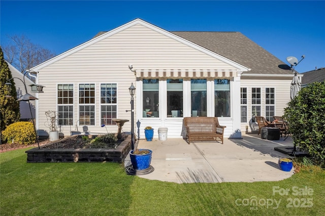 rear view of property featuring a patio area, a lawn, and an outdoor hangout area