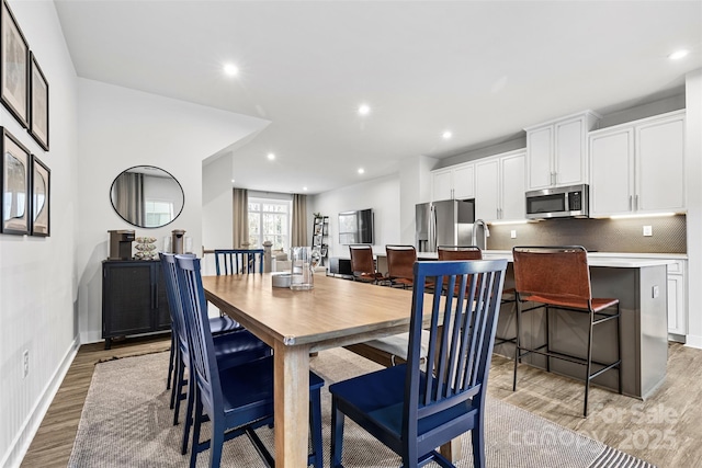 dining room with light hardwood / wood-style flooring