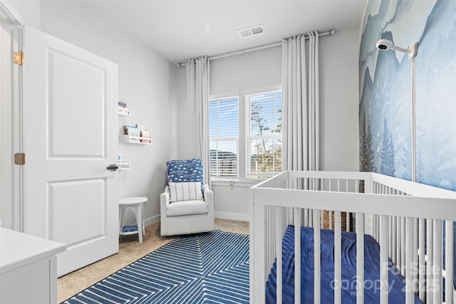 bedroom featuring a crib and carpet floors