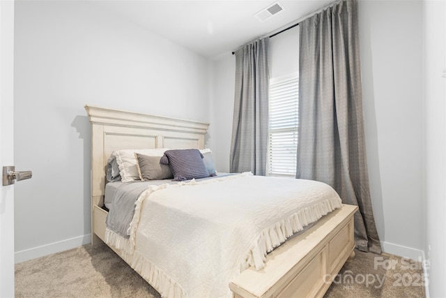 bedroom featuring light colored carpet