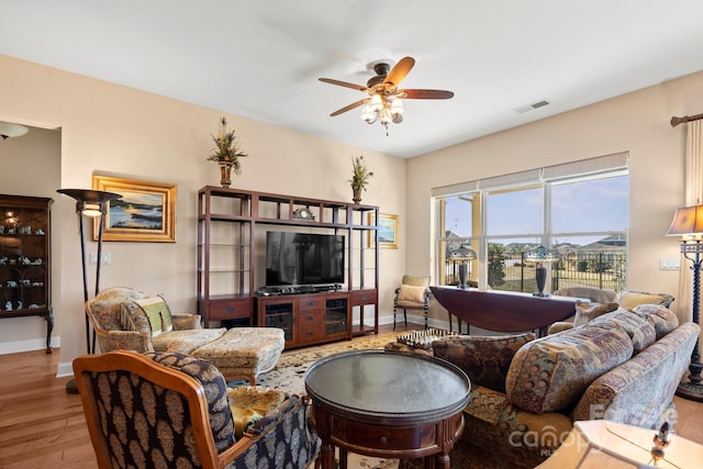 living room with ceiling fan and light hardwood / wood-style flooring