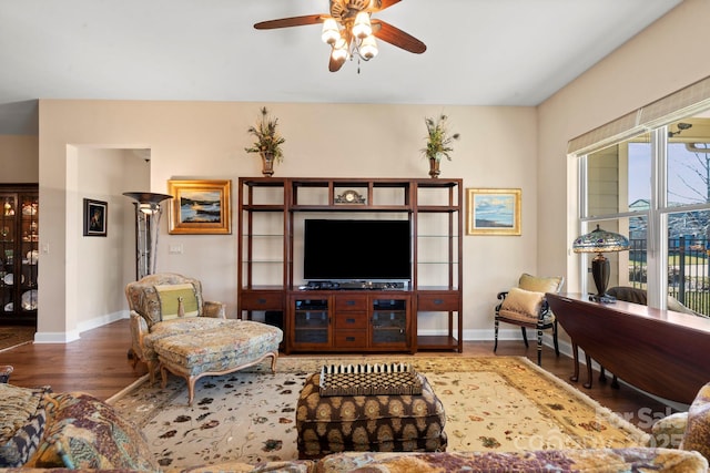 living room with ceiling fan and dark hardwood / wood-style flooring