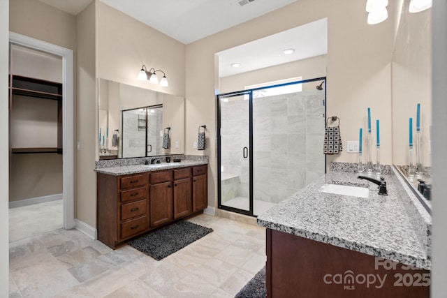 bathroom featuring vanity and a shower with shower door