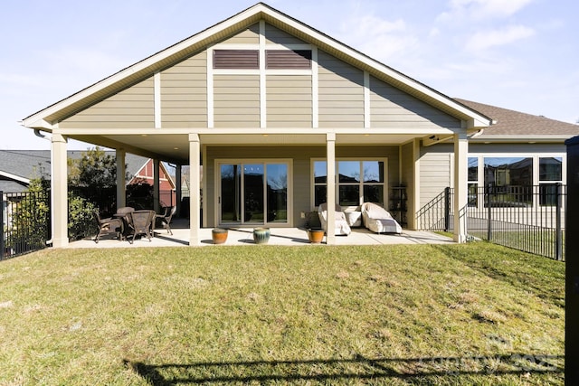 back of property with a lawn and a patio area