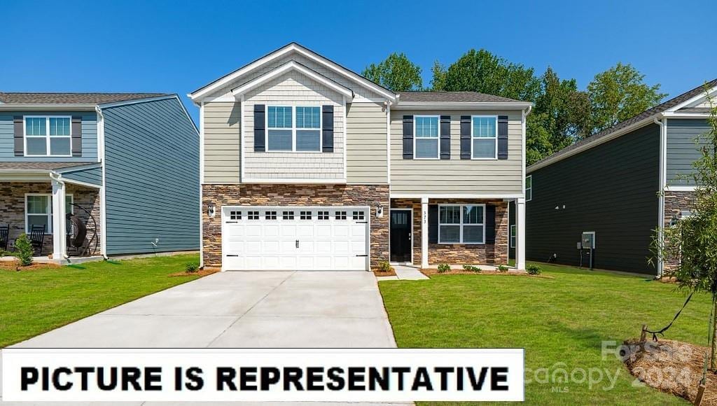 view of front of house featuring a front yard and a garage