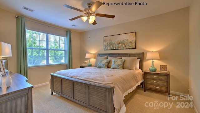 bedroom with ceiling fan and light colored carpet