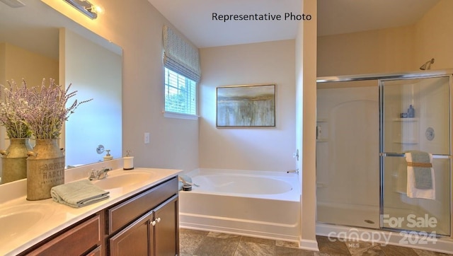 bathroom with vanity and separate shower and tub