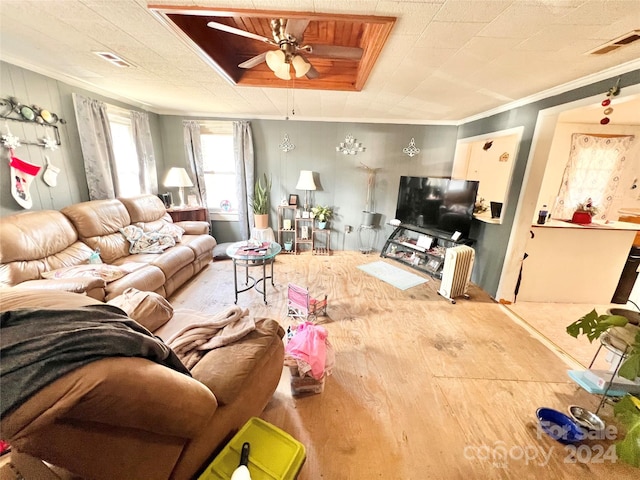 living room with crown molding, ceiling fan, and hardwood / wood-style flooring