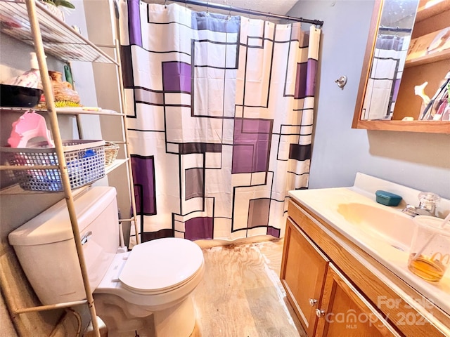 bathroom featuring hardwood / wood-style floors, vanity, and toilet