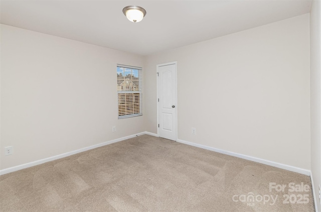 unfurnished room featuring baseboards and carpet