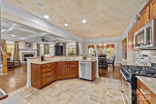 kitchen with beam ceiling, sink, coffered ceiling, decorative light fixtures, and appliances with stainless steel finishes