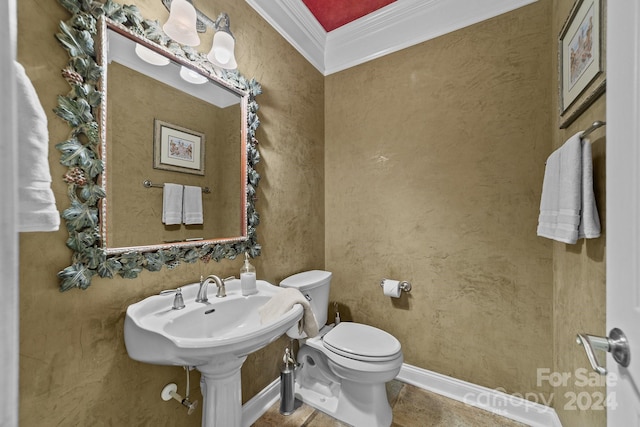 bathroom with toilet and ornamental molding