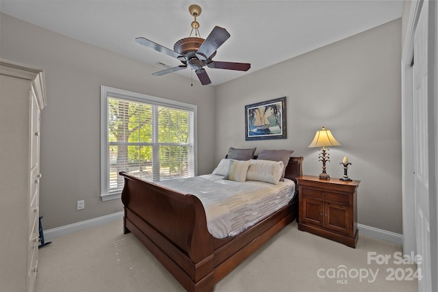 bedroom with light carpet and ceiling fan