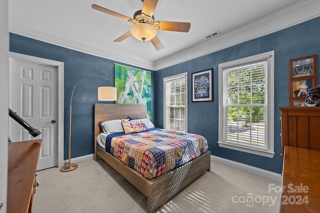 bedroom featuring light carpet, ceiling fan, and ornamental molding