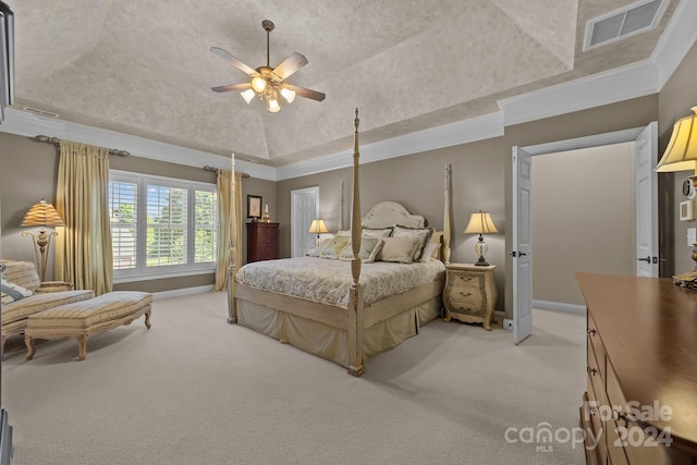 carpeted bedroom featuring a raised ceiling, ceiling fan, vaulted ceiling, and ornamental molding