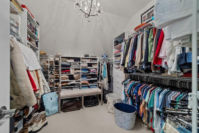 spacious closet with carpet and a notable chandelier