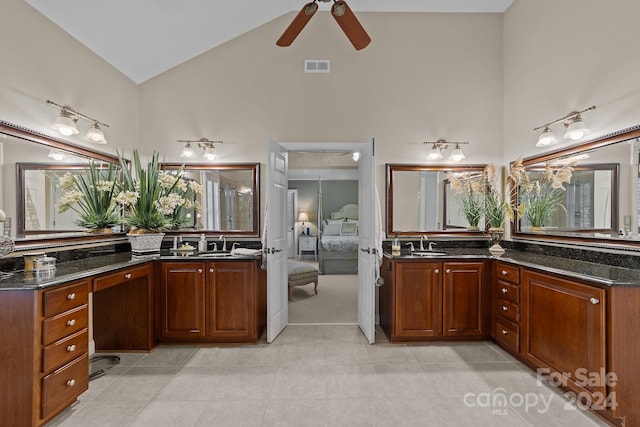 bathroom featuring ceiling fan, tile patterned flooring, vanity, and high vaulted ceiling