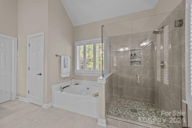 bathroom with tile patterned flooring, lofted ceiling, and plus walk in shower