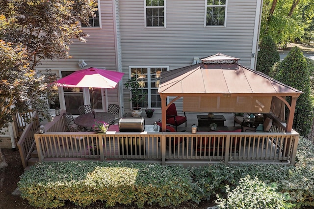 deck featuring a gazebo and outdoor lounge area