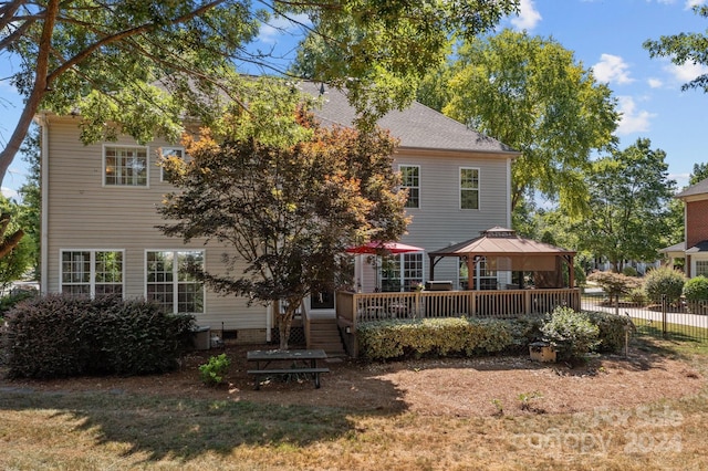 rear view of property featuring a gazebo and a deck