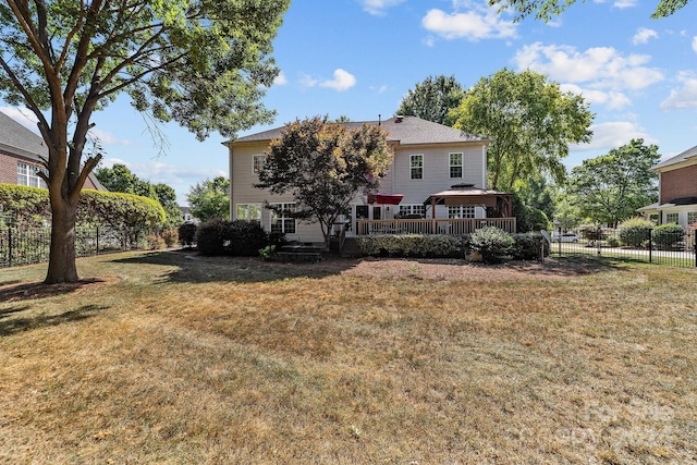 rear view of house featuring a lawn