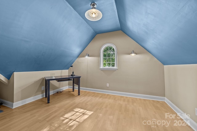 additional living space featuring hardwood / wood-style flooring and lofted ceiling