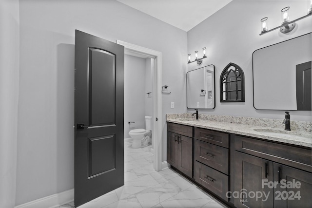 bathroom with vanity and toilet