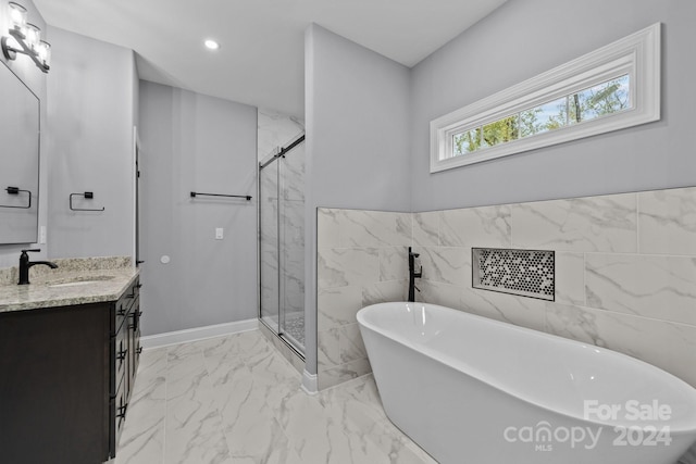 bathroom with vanity, tile walls, and independent shower and bath