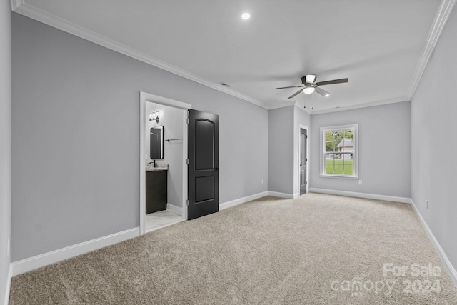 unfurnished bedroom with ensuite bathroom, ceiling fan, crown molding, and light colored carpet