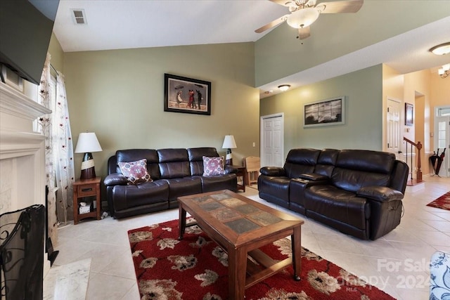 living room with ceiling fan, light tile patterned flooring, and lofted ceiling