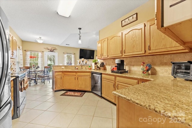 kitchen featuring pendant lighting, sink, light tile patterned floors, appliances with stainless steel finishes, and kitchen peninsula